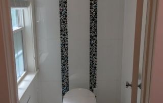 Remodeled half-bath with toilet and tile